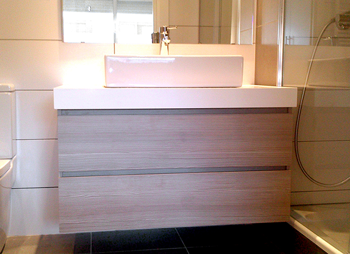 Mueble de baño suspendido a medida en melamina imitación madera. Cajones con guía de extracción total con freno.