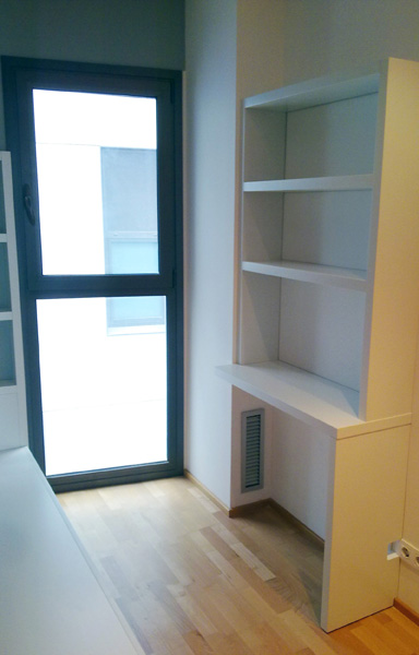 Habitación juvenil a medida con cama, escritorio y librería lacada en blanco.